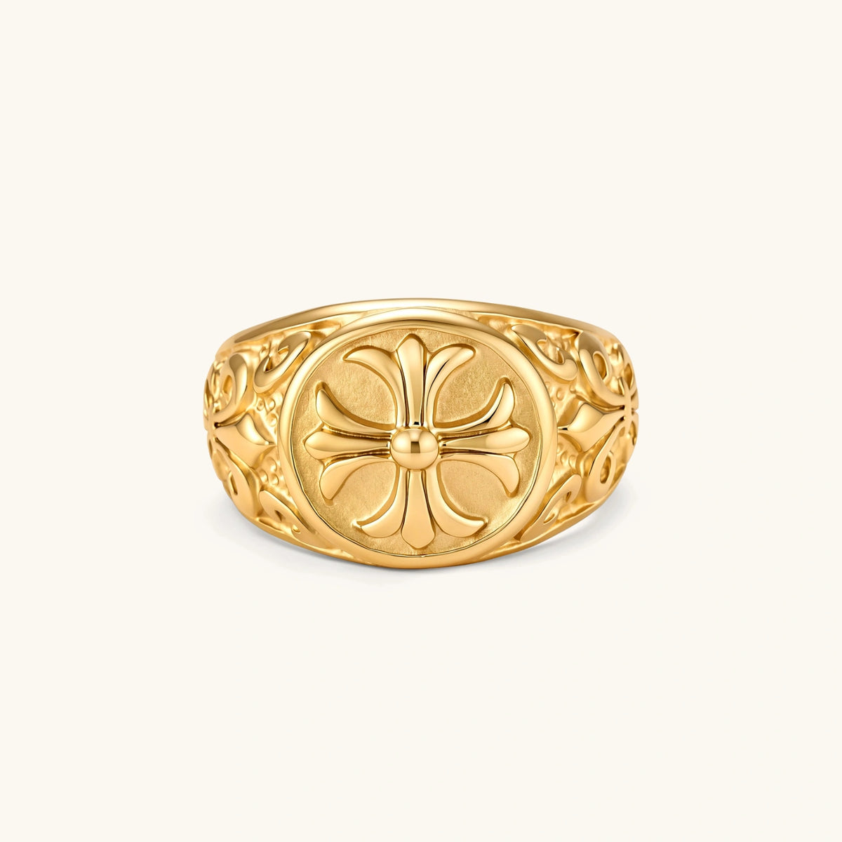 18K gold-plated stainless steel signet ring with ornate cross face and carved filigree scroll band, shown from three angles.