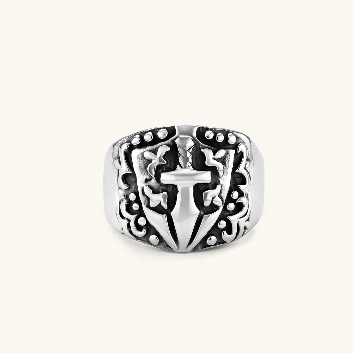 Silver 316L stainless steel men's signet ring with raised knight shield, cross motif, and ornate blackened scrollwork detailing.