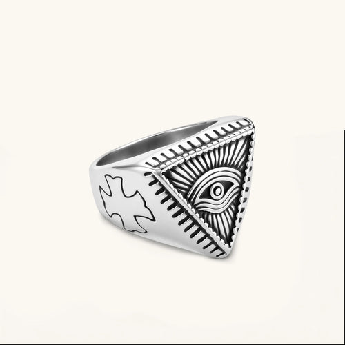 Silver stainless steel signet ring with engraved all-seeing eye in triangle, radiating lines, and cross motifs on the band.