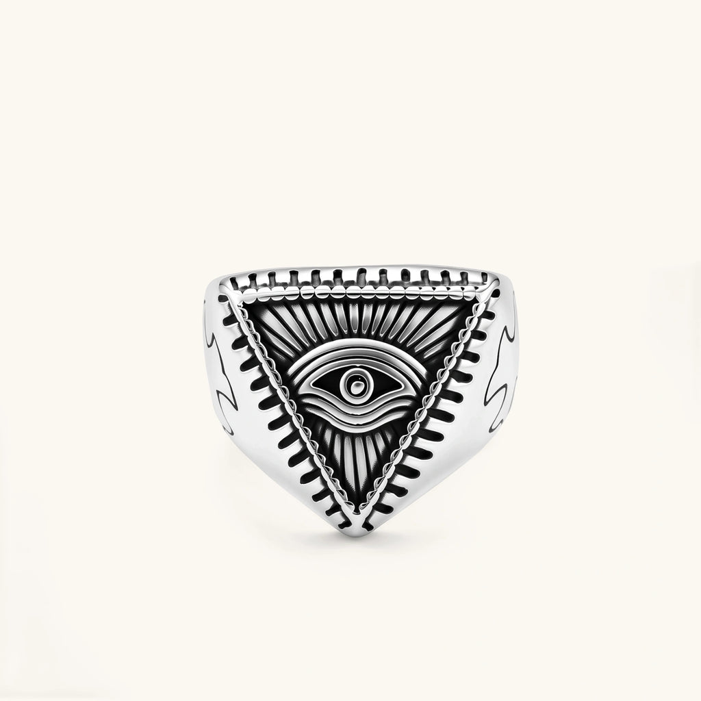 Silver stainless steel signet ring with engraved all-seeing eye in triangle, radiating lines, and cross motifs on the band.