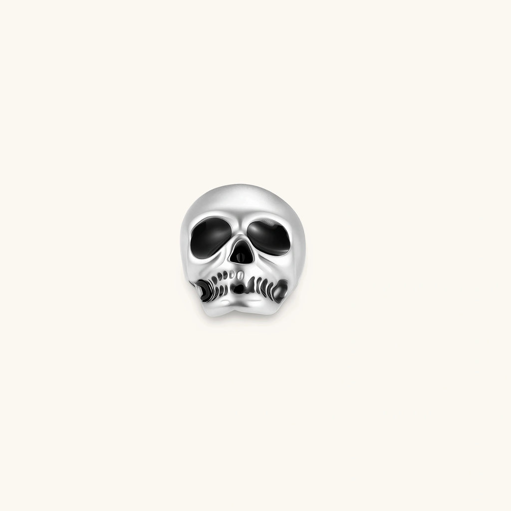 Matte silver skull stud earring with black enamel eye sockets and detailed teeth, post backing, 316L stainless steel.