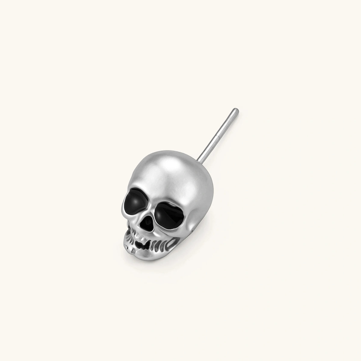 Matte silver skull stud earring with black enamel eye sockets and detailed teeth, post backing, 316L stainless steel.
