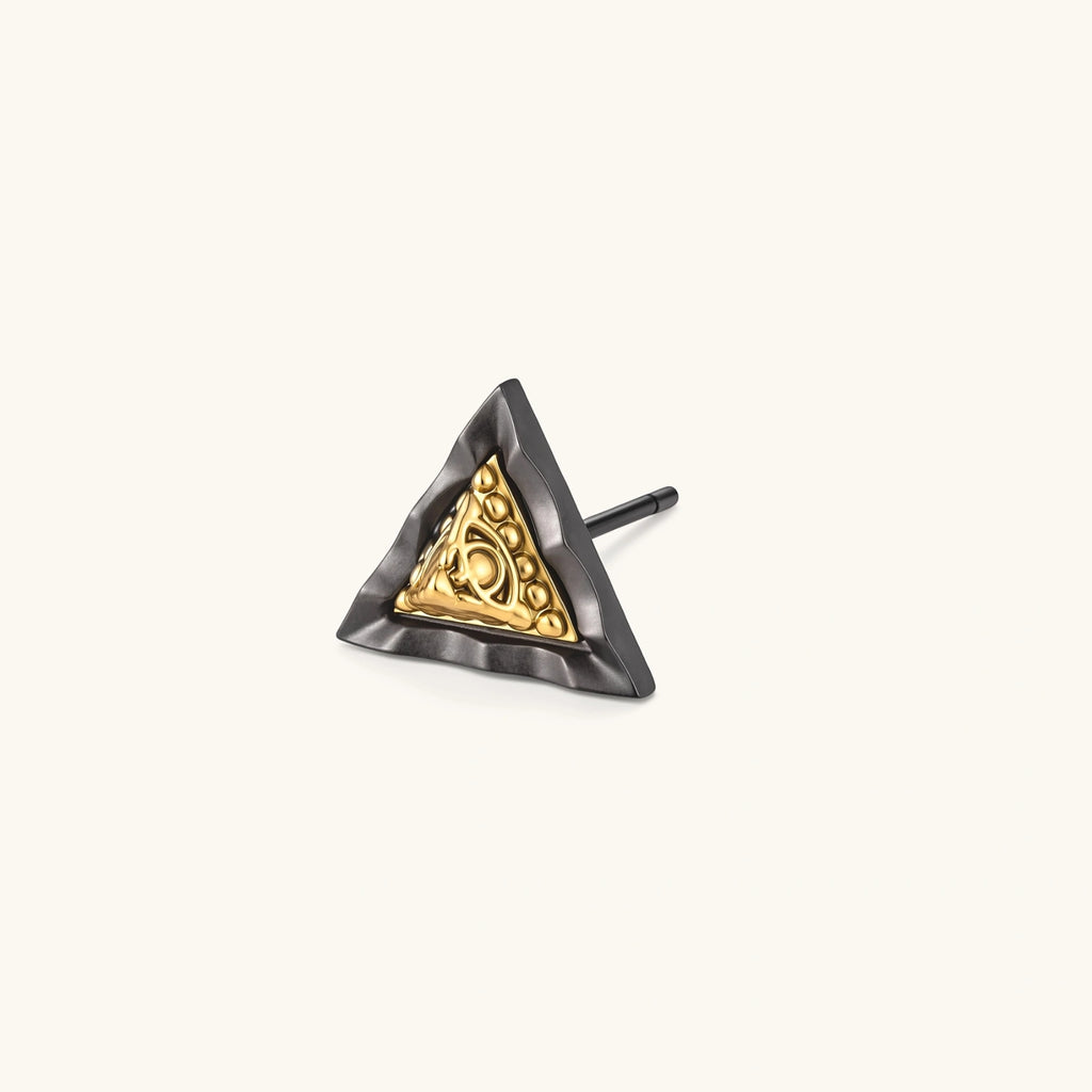 Single triangle stud earring with dark gunmetal outer frame and raised 18K gold-plated ornamental center, post back.
