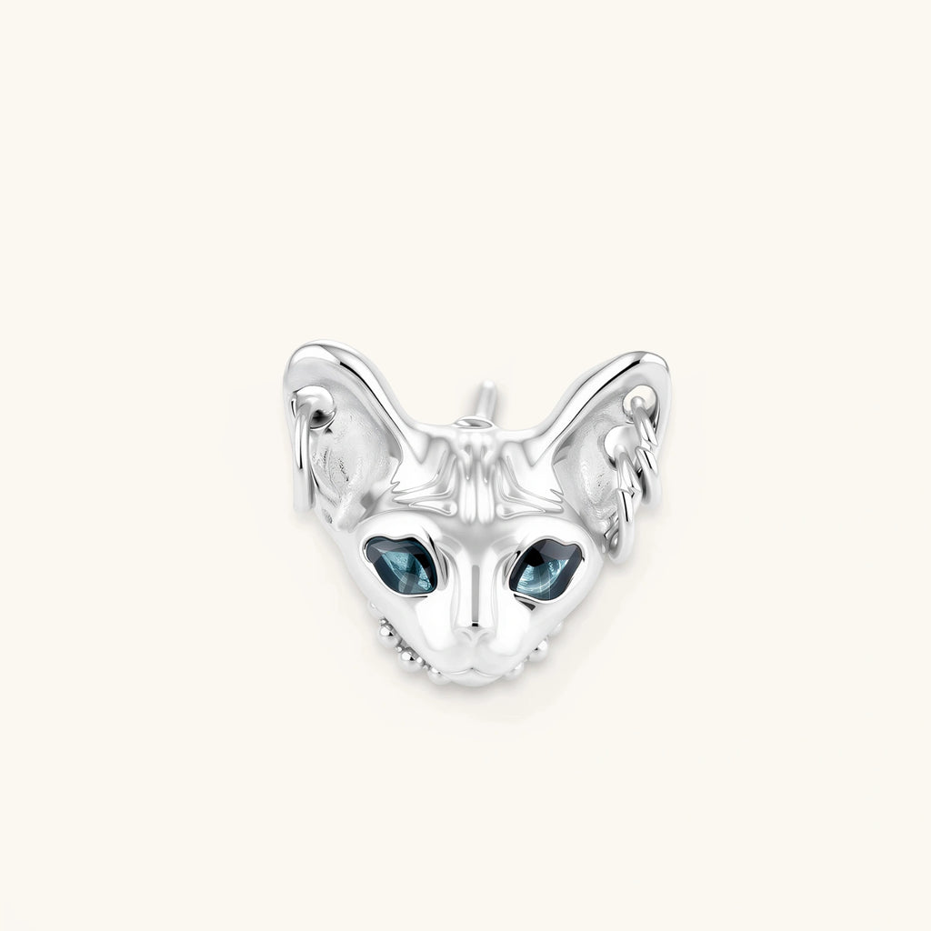 3D sculpted stainless steel Sphynx cat head stud earring with blue CZ eyes and hoop ear details, silver finish.