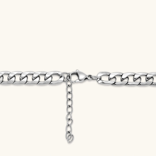 Silver 316L stainless steel carved curb chain necklace with lobster clasp and extender, 7.2mm wide, on cream background.