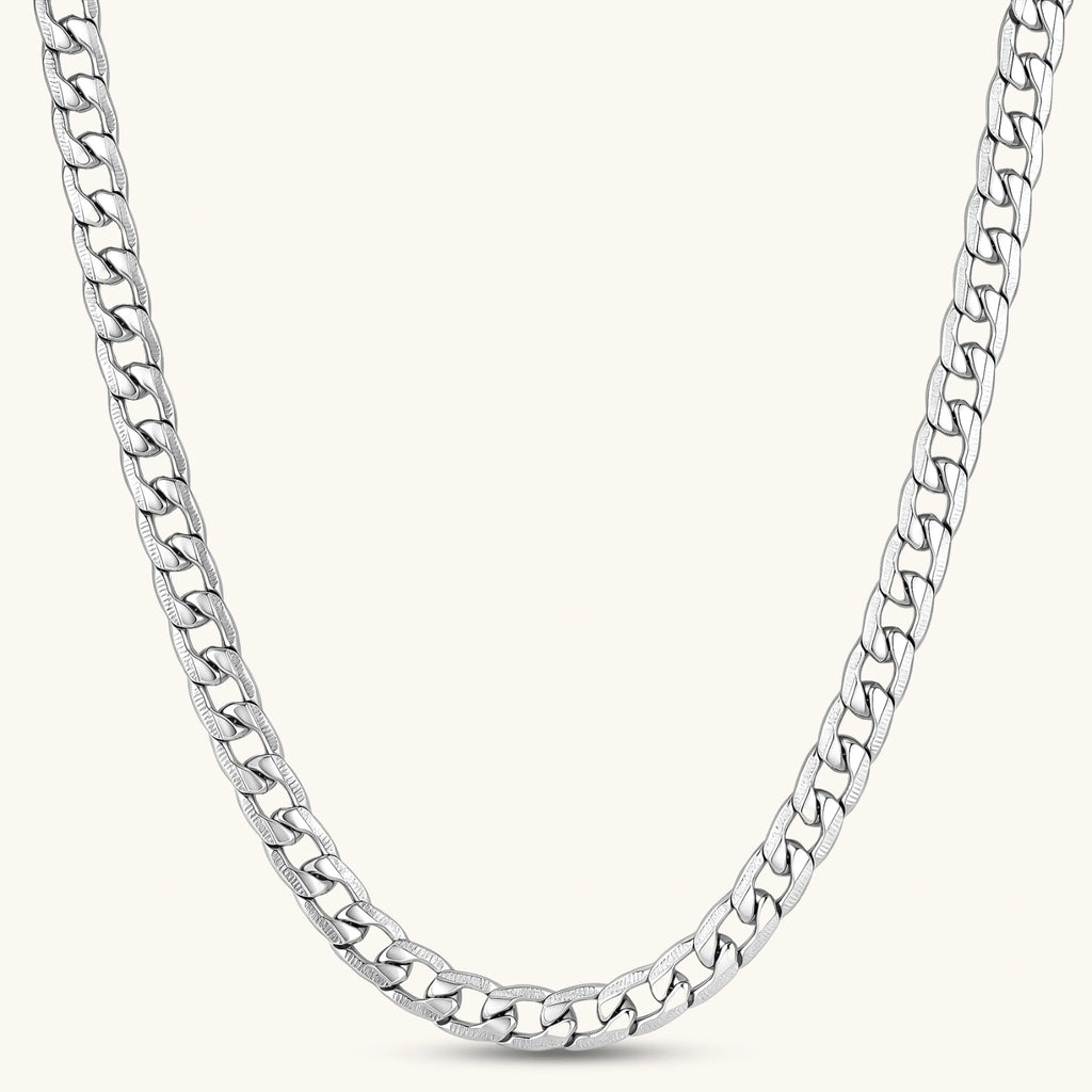 Silver 316L stainless steel carved curb chain necklace with lobster clasp and extender, 7.2mm wide, on cream background.
