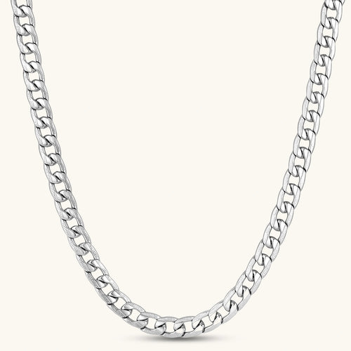 Silver 316L stainless steel carved curb chain necklace with lobster clasp and extender, 7.2mm wide, on cream background.