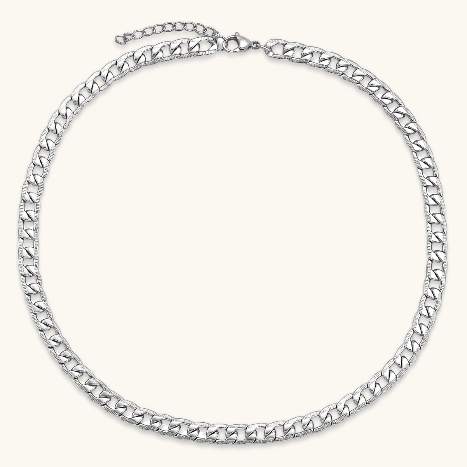 Silver 316L stainless steel carved curb chain necklace with lobster clasp and extender, 7.2mm wide, on cream background.