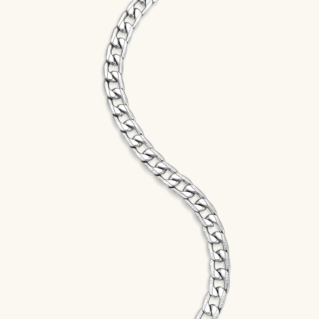 Silver 316L stainless steel carved curb chain necklace with lobster clasp and extender, 7.2mm wide, on cream background.