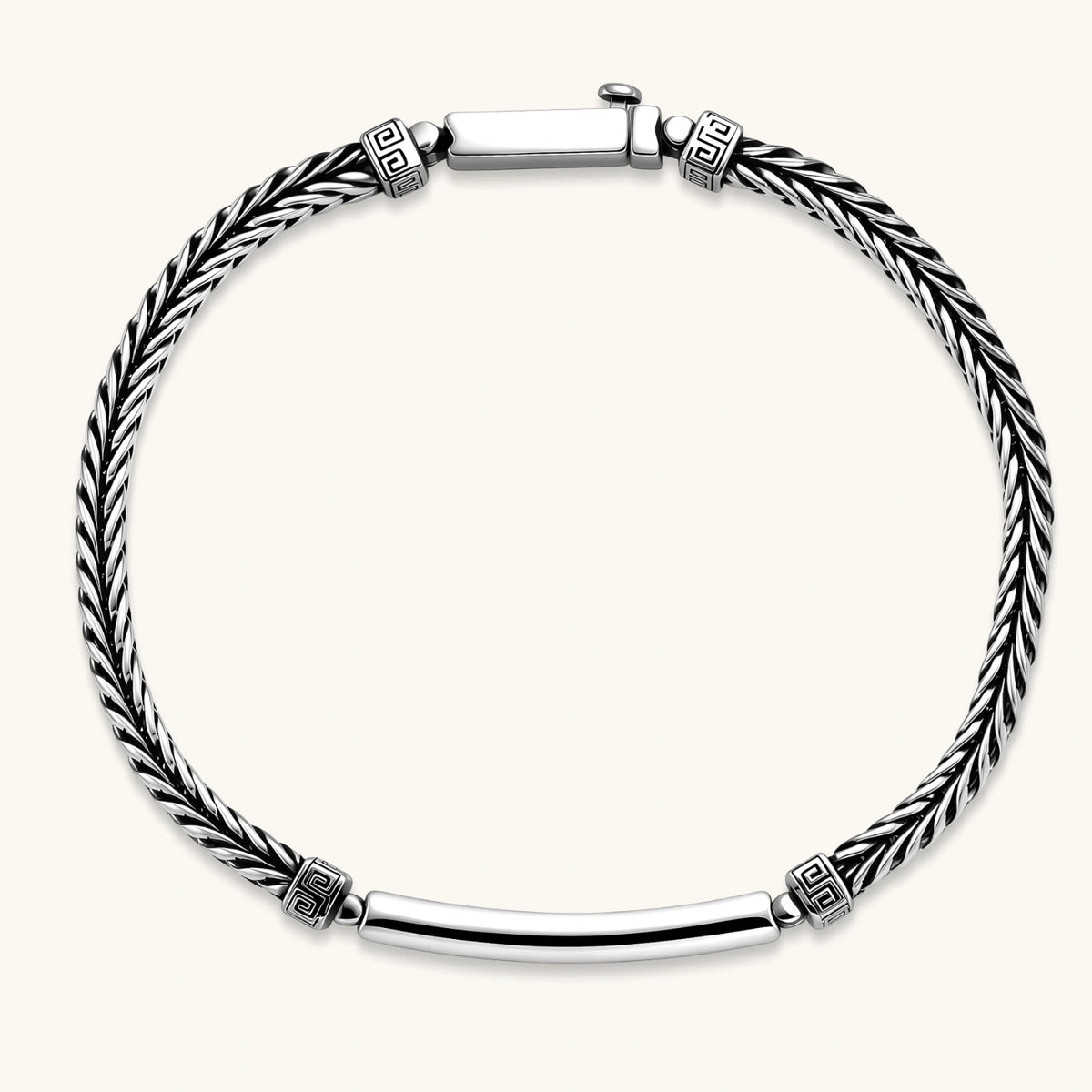 Silver stainless steel men's bracelet with braided foxtail chain, Greek key engraved bar, and decorative cube connectors.