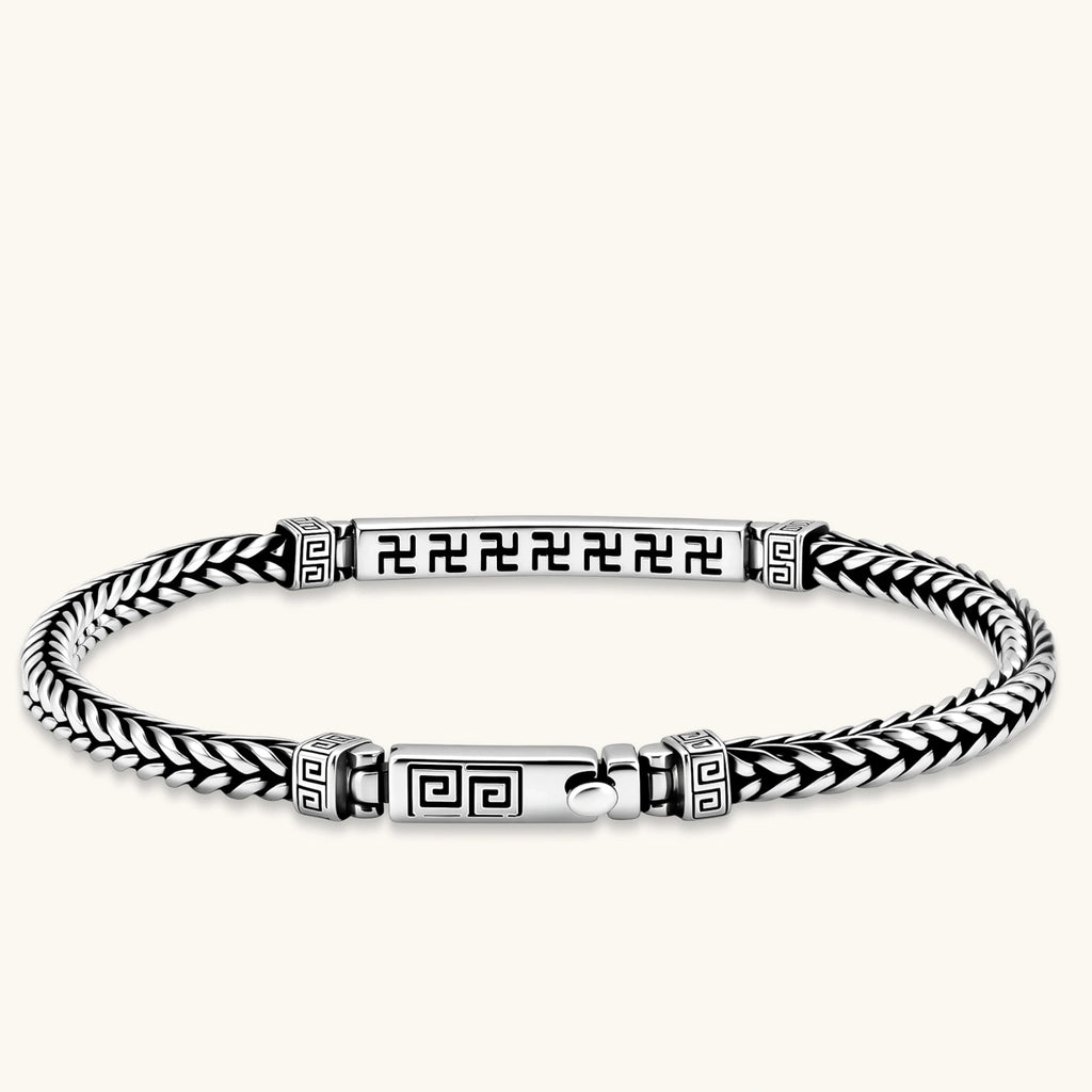 Silver stainless steel men's bracelet with braided foxtail chain, Greek key engraved bar, and decorative cube connectors.