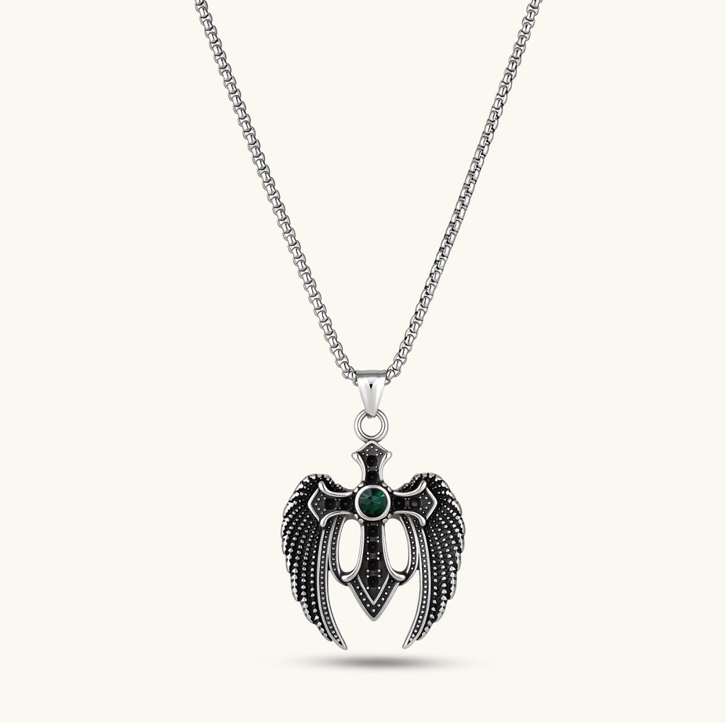 Silver stainless steel angel wing cross pendant necklace with green CZ center stone and black crystals on a box chain.