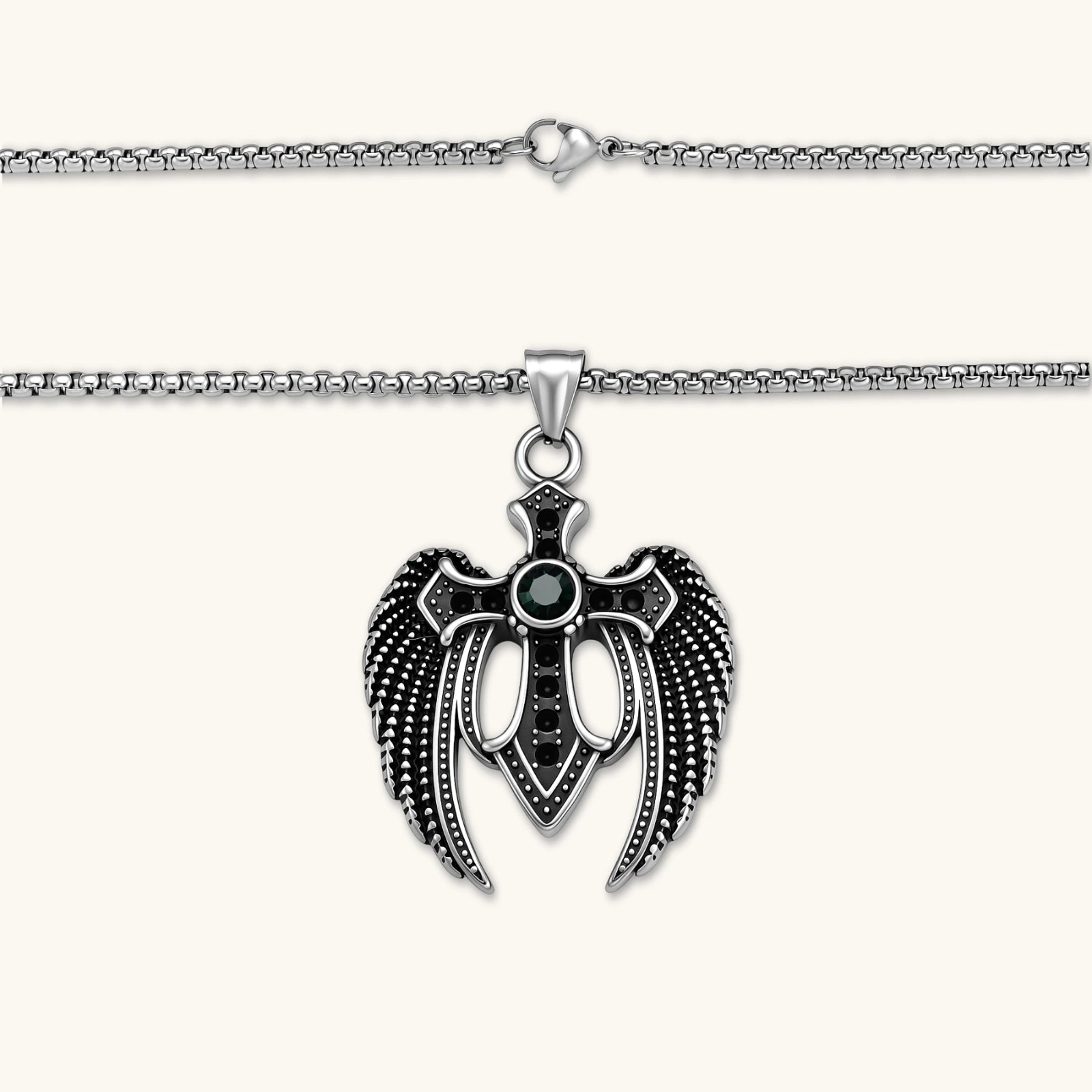 Silver stainless steel angel wing cross pendant necklace with green CZ center stone and black crystals on a box chain.