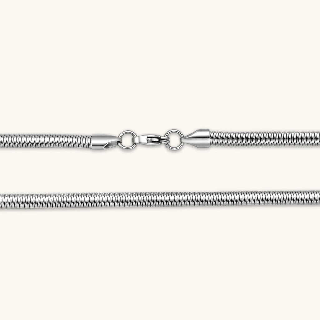 Two-tone twisted necklace with interlocked gold and silver ribbed snake chains, 6mm wide, on a white background.