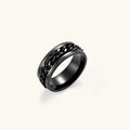 Black PVD-plated stainless steel band ring with a rotating Cuban chain center strip and ridged edges, 8mm wide.