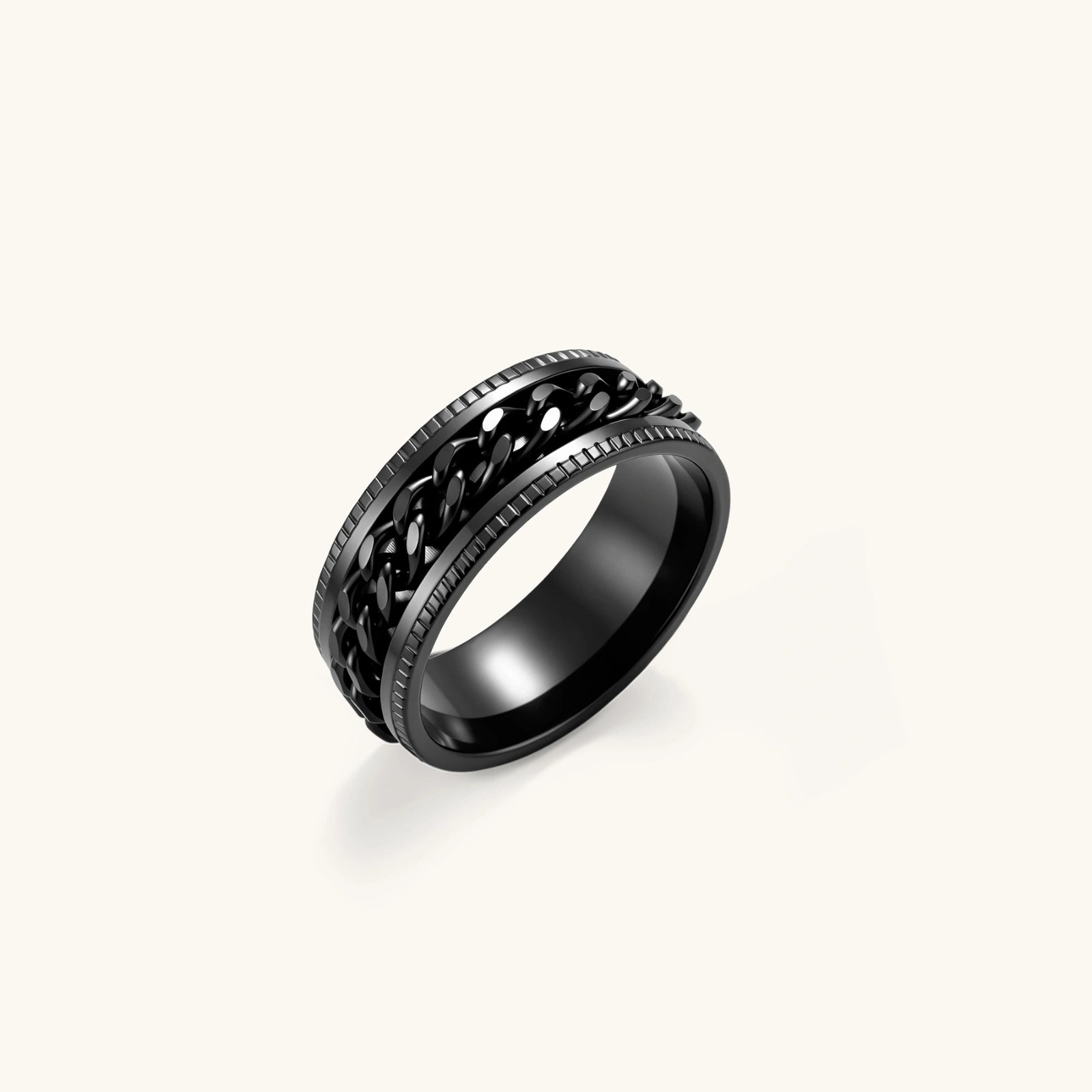 Black PVD-plated stainless steel band ring with a rotating Cuban chain center strip and ridged edges, 8mm wide.