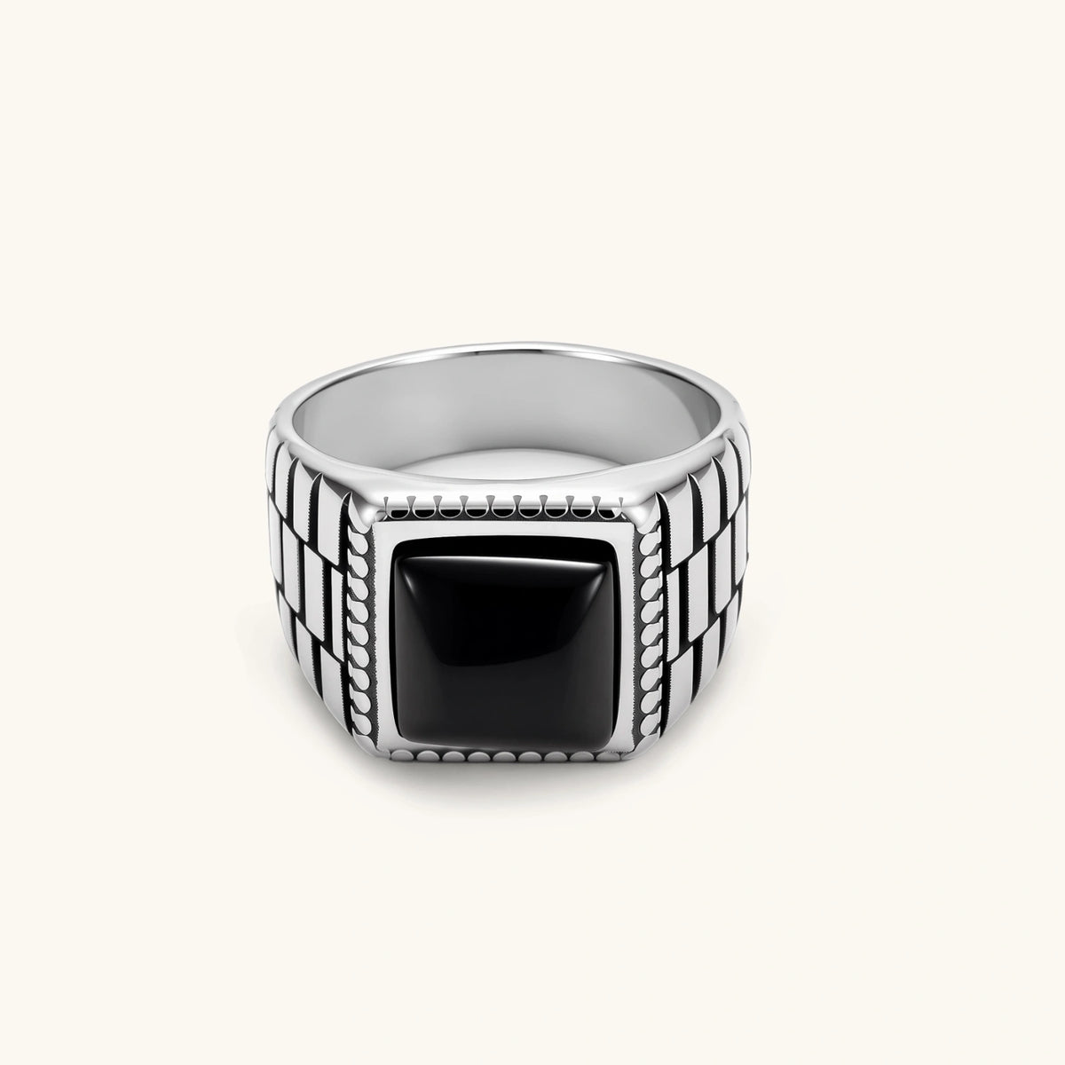 Silver stainless steel signet ring with checkered band texture, beaded border, and square black onyx cabochon stone center.
