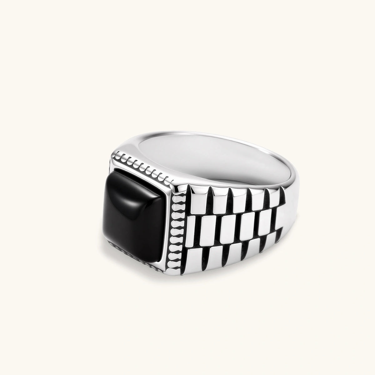 Silver stainless steel signet ring with checkered band texture, beaded border, and square black onyx cabochon stone center.